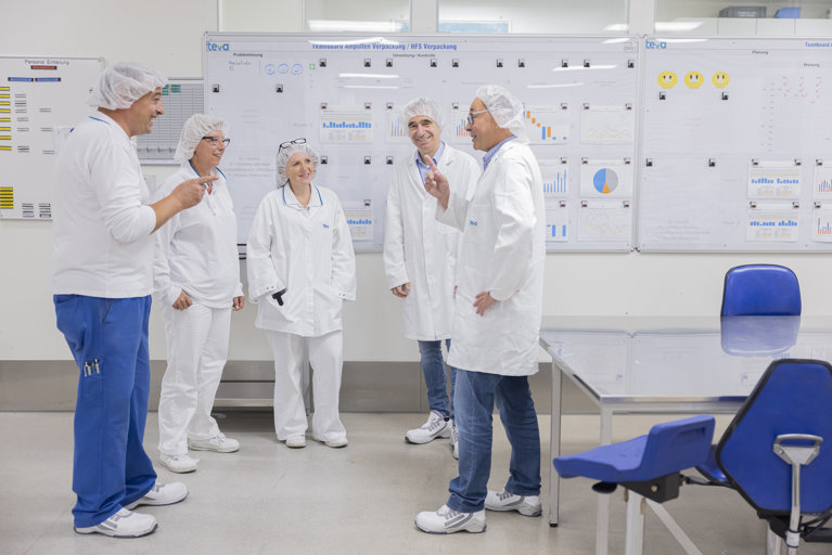 Teva employees talking in a circle