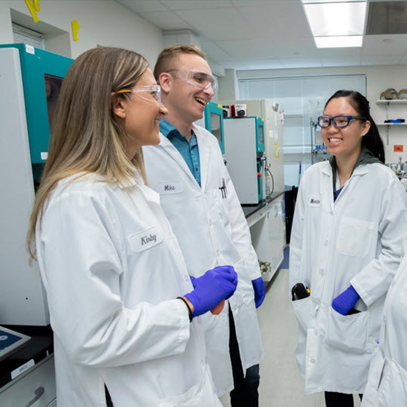 Four lab-coated professionals share ideas, emphasizing Teva's commitment to improving health daily.
