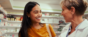 A pharmacist and a customer in a pharmacy.