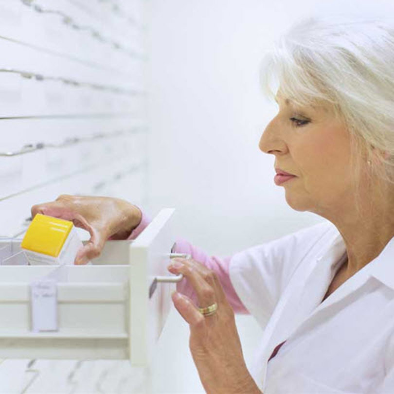 A pharmacist searching for medicine