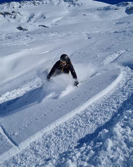 Ran skiing down the slopes.