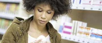 woman looking at generic medicines pharmacy