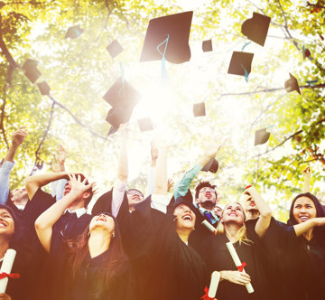 a-group-of-graduating-students-toss-their-academic-caps-in-the-air-in-celebration