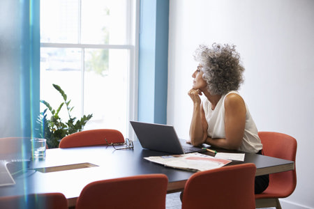 A woman with ADHD gazes out the window, distracted by the view outside.
