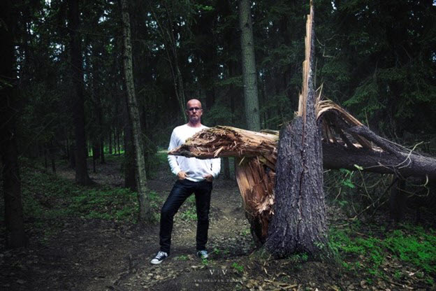 man-standing-in-front-of-a-fallen-tree.jpg