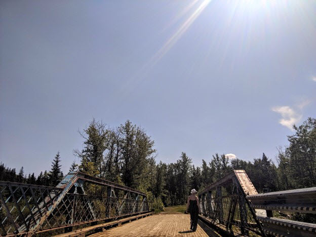 woman-in-nature-walking-on-a-bridge.jpg