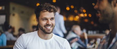 man smiling and drinking coffe