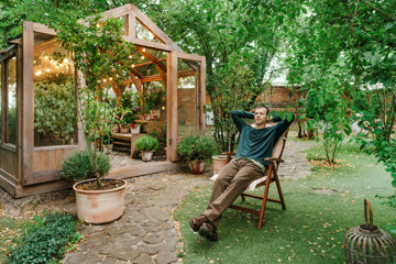 Man relaxing in his garden, visualizing and practicing imagery meditation