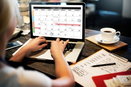 woman-checking-calendar on a laptop