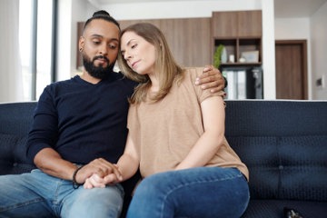 Young couple supporting one another in the aftermath of cancer treatment